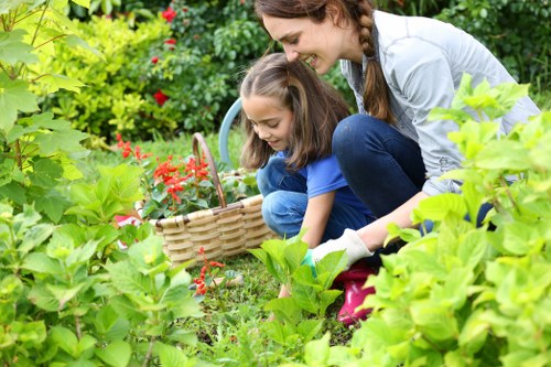Gardener inspecting a front garden with tools and notes